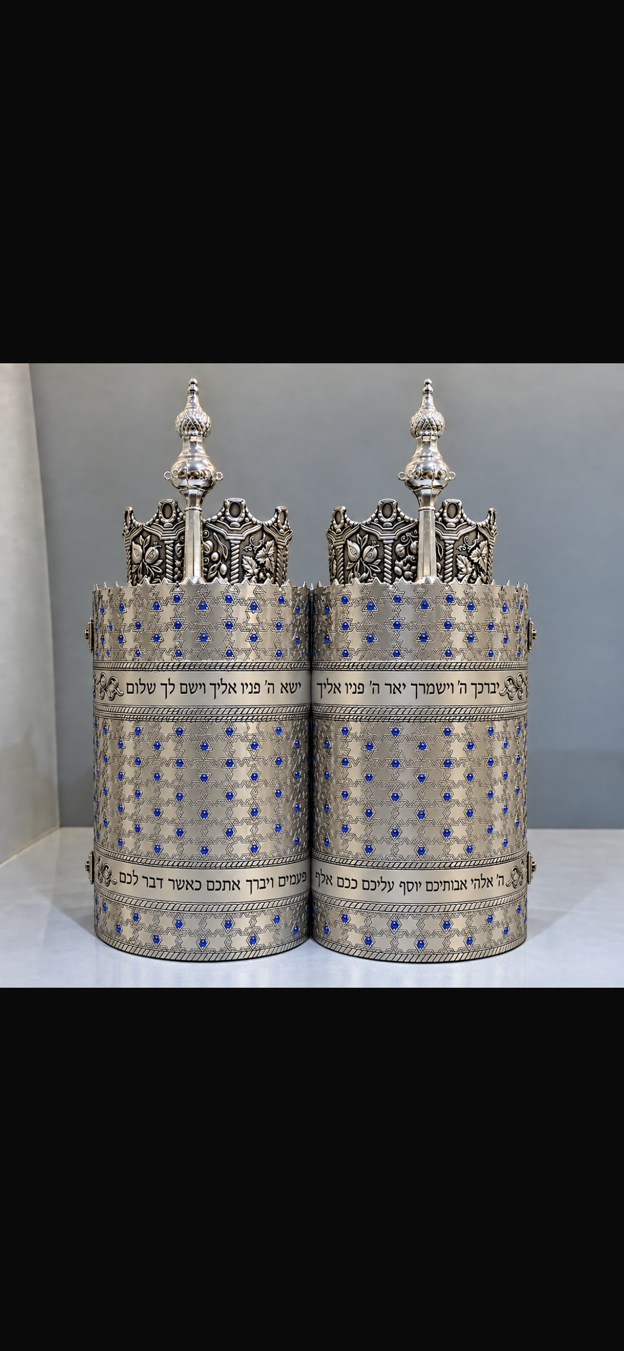 The new Sefer Torah’s silver case, set with blue stones in a pattern of stars and engraved with Birkat Kohanim